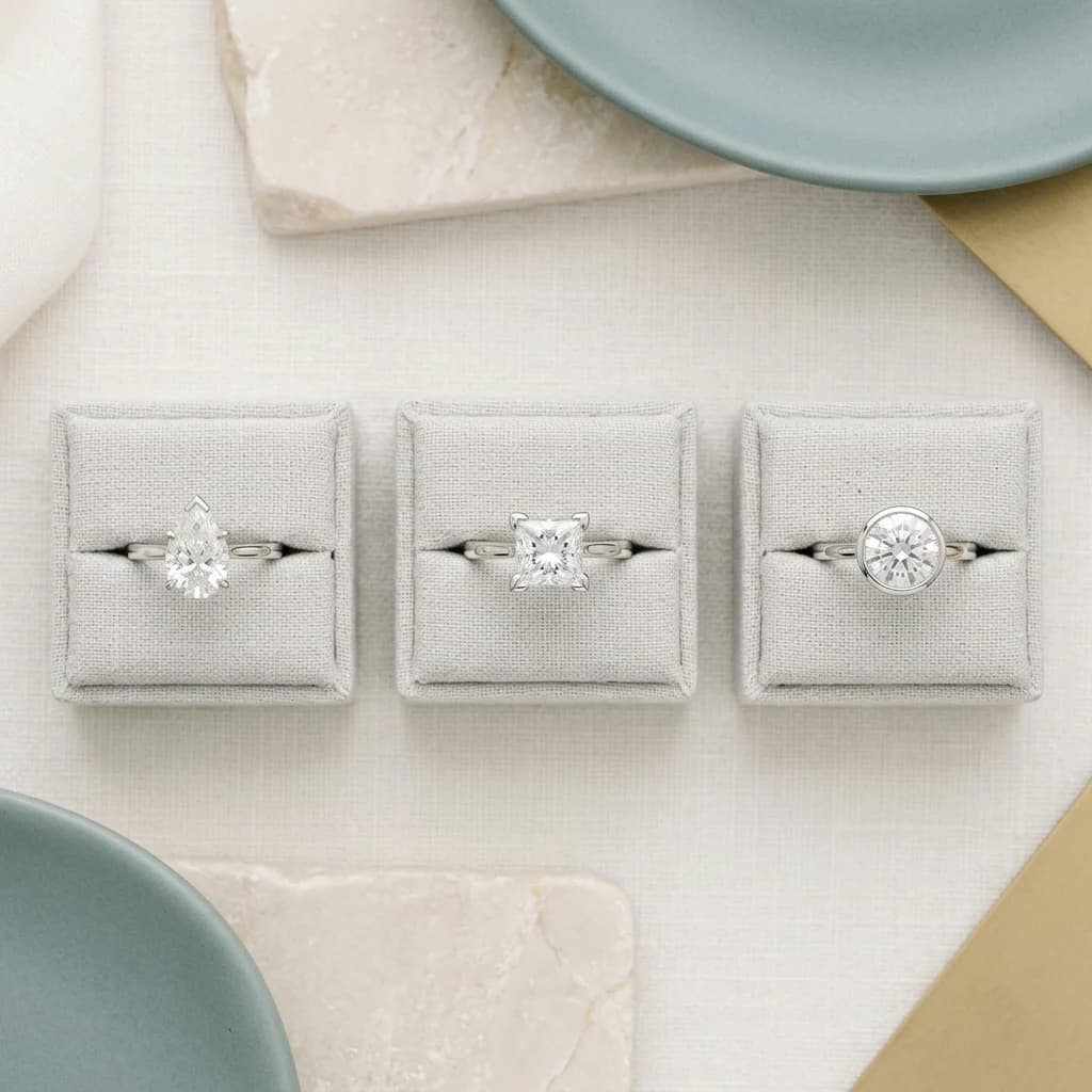 Pear, princess and round diamond rings illustrating point, corner and bezel setting protection
